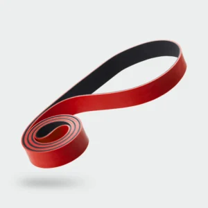 116000_-_Deuser_Band_-_Original_-_Hauptbild_3000x - Deuser Sports | Solingen Red and black elastic strap curling diagonally across a pale background, showing the textured inner side and glossy red exterior.